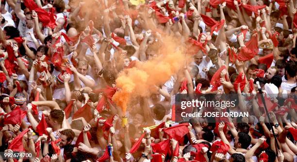 Participants celebrate during the 'Chupinazo' to mark the kickoff at noon sharp of the San Fermin Festival, in front of the Town Hall of Pamplona,...