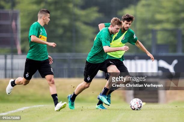 Christoph Kramer and Tobias Strobl battle for the ball during a training session of Borussia Moenchengladbach at Borussia-Park on July 05, 2018 in...