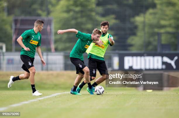 Christoph Kramer and Tobias Strobl battle for the ball during a training session of Borussia Moenchengladbach at Borussia-Park on July 05, 2018 in...