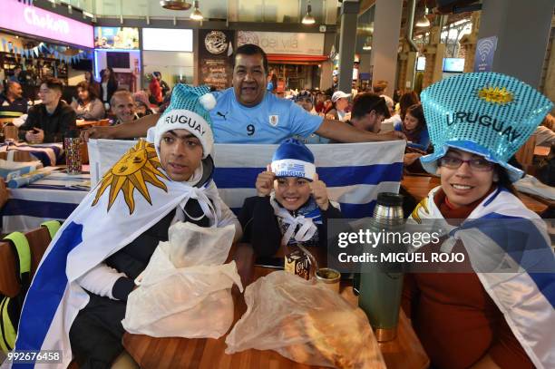 Fans of Uruguay attend the broadcasting of the Russia 2018 FIFA World Cup football match Uruguay against France on a big screen at the Mercado...