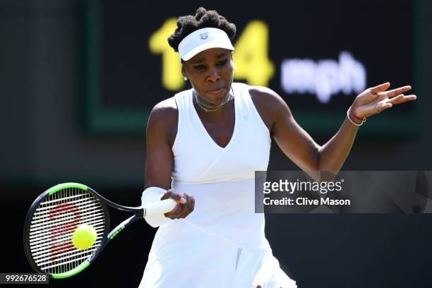 Venus Williams of the United States returns a shot against Kiki Bertens of the Netherlands during their Ladies' Singles third round match on day five...