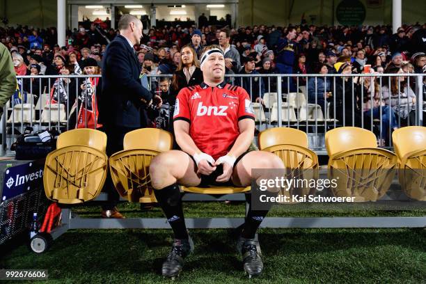Wyatt Crockett of the Crusaders sits on the bench prior to his 200th Super Rugby match during the round 18 Super Rugby match between the Crusaders...