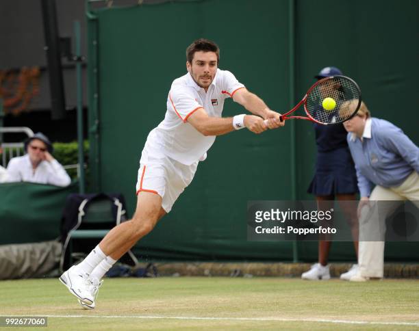 Colin Fleming of Great Britain returns the ball against Arnaud Clement and Nicolas Mahut of France in the Mens Doubles first round on day six of the...