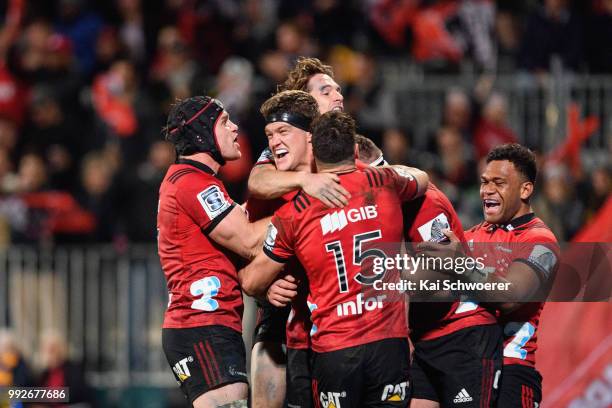 Scott Barrett of the Crusaders is congratulated by team mates after scoring a try during the round 18 Super Rugby match between the Crusaders and the...