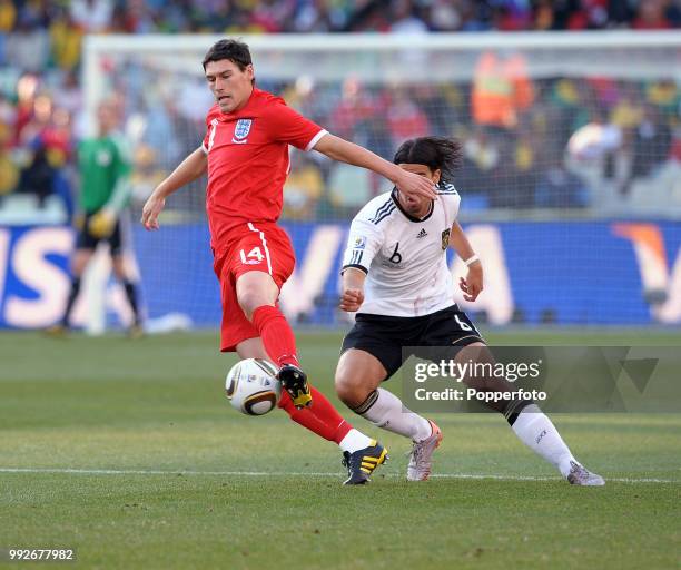 Gareth Barry of England is closed down by Sami Khedira of Germany during a FIFA World Cup Round of 16 match at the Free State Stadium on June 27,...