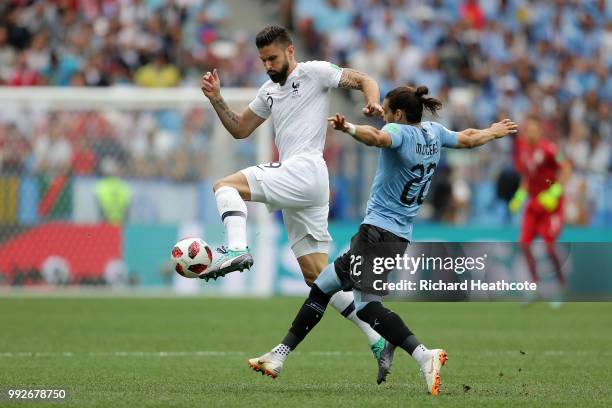 Martin Caceres of Uruguay and Olivier Giroud of France battle for the ball during the 2018 FIFA World Cup Russia Quarter Final match between Uruguay...