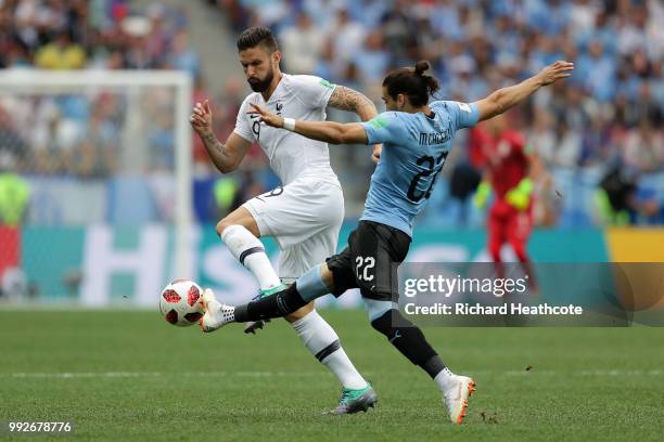 Martin Caceres of Uruguay and Olivier Giroud of France battle for the ball during the 2018 FIFA World Cup Russia Quarter Final match between Uruguay...