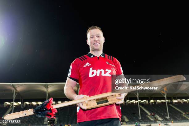 Wyatt Crockett of the Crusaders poses with a taiaha, a traditional Maori weapon, after his 200th Super Rugby match during the round 18 Super Rugby...