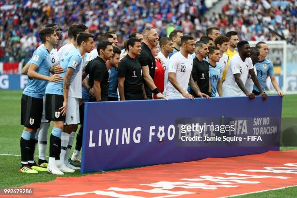 Uruguay and France players gather behind a FIFA Fair Play sign prior to the 2018 FIFA World Cup Russia Quarter Final match between Uruguay and France...