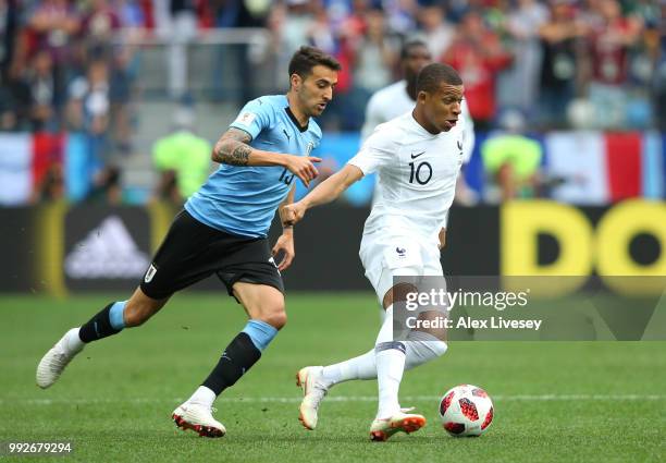 Matias Vecino of Uruguay and Kylian Mbappe of France battle for the ball during the 2018 FIFA World Cup Russia Quarter Final match between Uruguay...