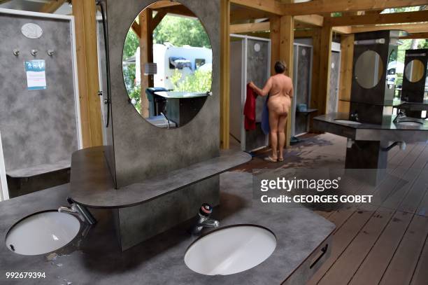Graphic content / A naked person stands at the shower of the Arnaoutchot naturist camping on June 26, 2018 in Vielle-Saint-Girons, southwestern...