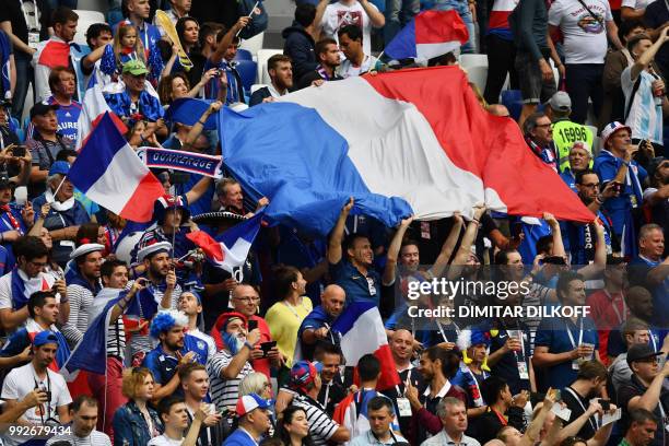 France supporter wave the national flag during the Russia 2018 World Cup quarter-final football match between Uruguay and France at the Nizhny...