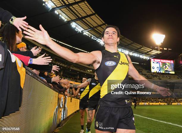 Daniel Rioli of the Tigers high fives fans after winning the round 16 AFL match between the Richmond Tigers and the Adelaide Crows at Melbourne...