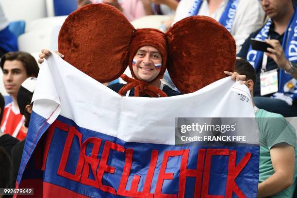 Russia fan disguised as Russian cartoon character Cheburashka poses before the Russia 2018 World Cup quarter-final football match between Uruguay and...