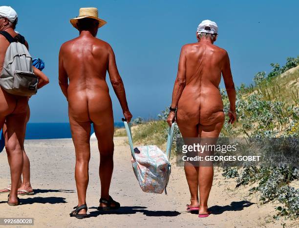 Graphic content / Naked people walk to the beach of the Arnaoutchot naturist camping on June 26, 2018 in Vielle-Saint-Girons, southwestern France. -...