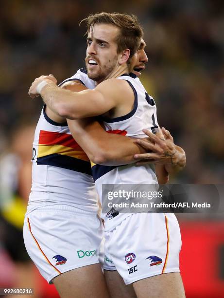 Jordan Gallucci of the Crows celebrates a score with Curtly Hampton of the Crows during the 2018 AFL round 16 match between the Richmond Tigers and...