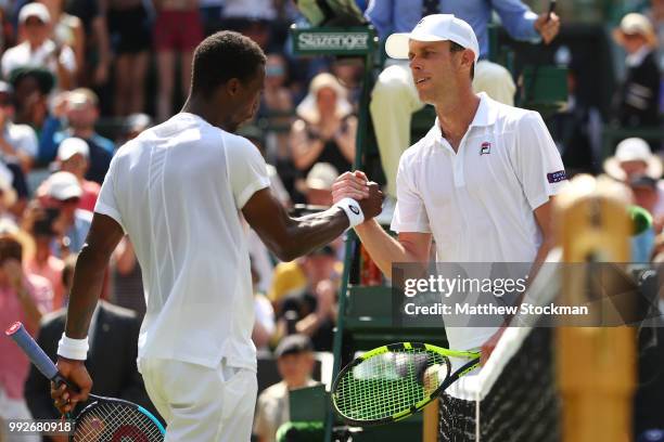 Gael Monfils of France shakes hands with Sam Querrey of the United States after their Men's Singles third round match on day five of the Wimbledon...