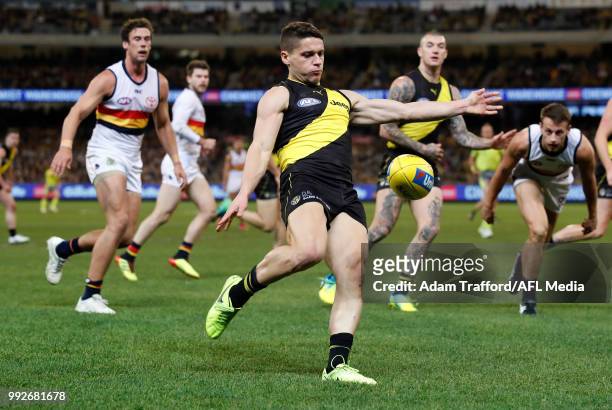 Dion Prestia of the Tigers kicks the ball during the 2018 AFL round 16 match between the Richmond Tigers and the Adelaide Crows at the Melbourne...