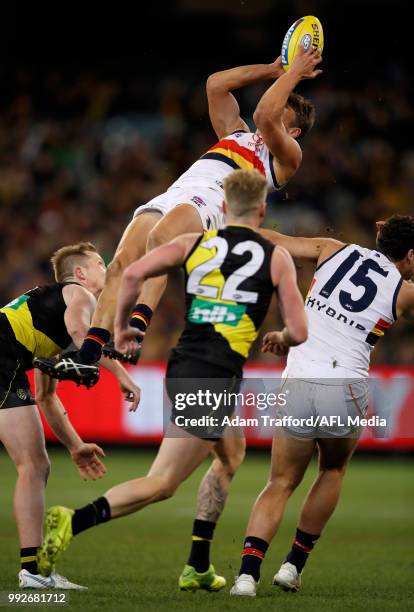 Tom Doedee of the Crows takes a spectacular mark over Jack Riewoldt of the Tigers during the 2018 AFL round 16 match between the Richmond Tigers and...