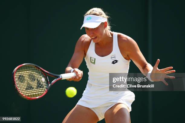 Yanina Wickmayer of Belgium returns a shot against Donna Vekic of Croatia during their Ladies' Singles third round match on day five of the Wimbledon...