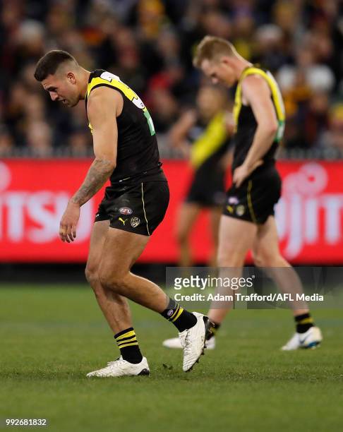 Jack Graham of the Tigers leaves the field injured during the 2018 AFL round 16 match between the Richmond Tigers and the Adelaide Crows at the...