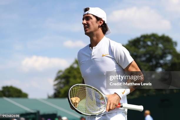 Thanasi Kokkinakis looks on against Fabrice Martin of France and Raluca Olaru of Romania during their Mix Doubles first round match on day five of...