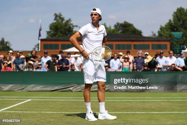 Thanasi Kokkinakis looks on against Fabrice Martin of France and Raluca Olaru of Romania during their Mix Doubles first round match on day five of...