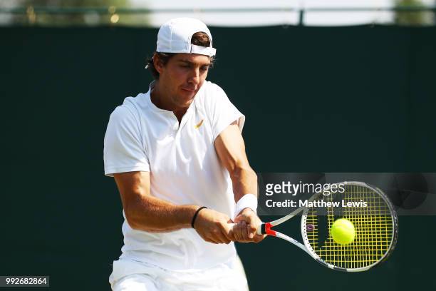 Thanasi Kokkinakis of Australia returns a shot against Fabrice Martin of France and Raluca Olaru of Romania during their Mix Doubles first round...