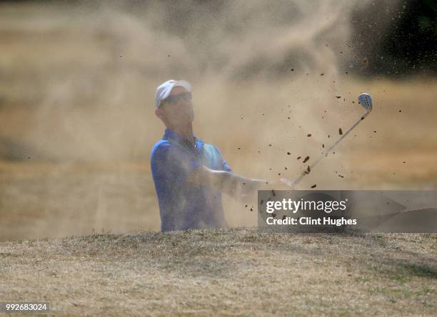 John Watson of Styal Golf Club plays out of a bunker on the 10th green during the Lombard Trophy North Qualifier at Fairhaven Golf Club on July 6,...