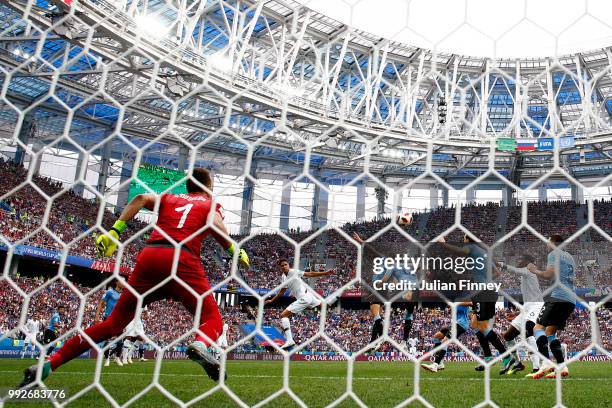 Raphael Varane of France scores his sides first goal past Fernando Muslera of Uruguay during the 2018 FIFA World Cup Russia Quarter Final match...