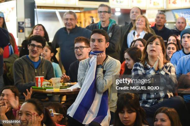 Fans of Uruguay attend the broadcasting of the Russia 2018 FIFA World Cup football match Uruguay against France on a big screen at the Mercado...