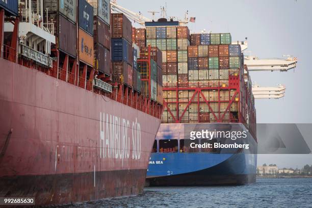 Container ships sit docked at the Port of Oakland in Oakland, California, U.S., on Tuesday, July 3, 2018. President Donald Trump threatened to impose...