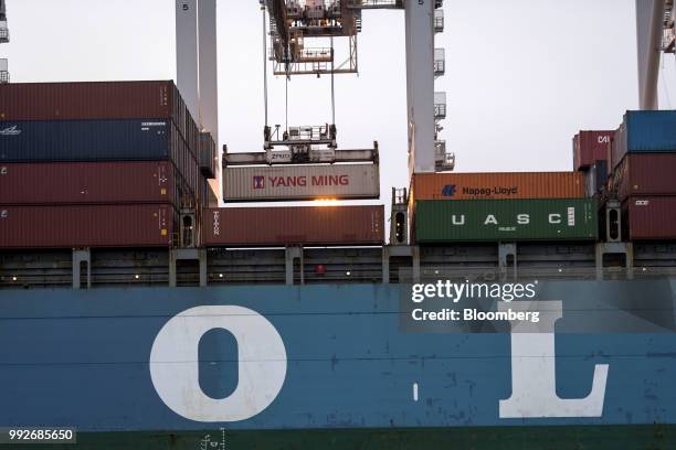 Shipping container is loaded onto the Mol Prestige ship at the Port of Oakland in Oakland, California, U.S., on Tuesday, July 3, 2018....