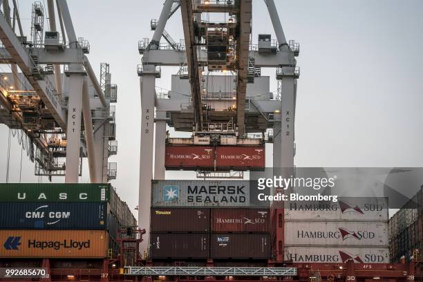 Hamburg Sud container is loaded onto a ship at the Port of Oakland in Oakland, California, U.S., on Tuesday, July 3, 2018. President Donald...