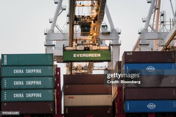 Shipping container is loaded onto a ship at the Port of Oakland in Oakland, California, U.S., on Tuesday, July 3, 2018. President Donald...