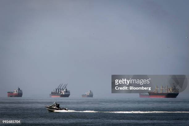Vessels sit anchored in San Francisco Bay near the Port of Oakland in Oakland, California, U.S., on Thursday, July 5, 2018. President Donald...