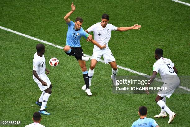 Uruguay's forward Cristhian Stuani vies for the ball with France's defender Raphael Varane during the Russia 2018 World Cup quarter-final football...