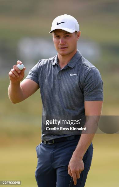 Oliver Fisher of Engand acknowledges the crowd after a birdie on the 18th green during the second round of the Dubai Duty Free Irish Open at...
