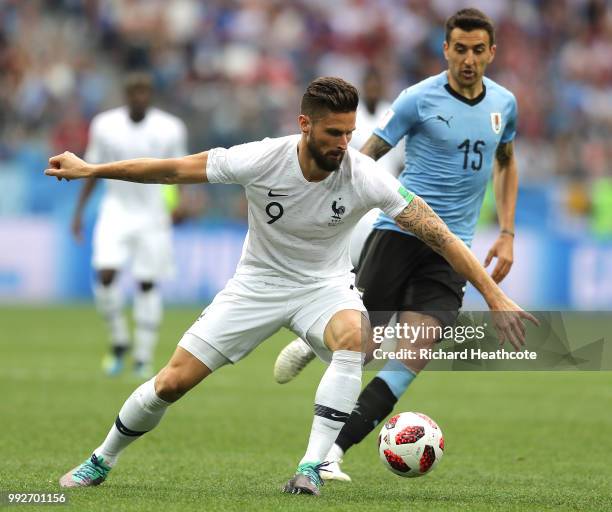 Olivier Giroud of France is tackled by Martin Caceres of Uruguay during the 2018 FIFA World Cup Russia Quarter Final match between Uruguay and France...