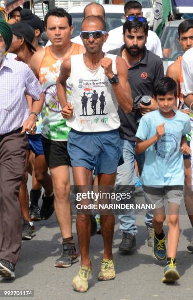 Indian runner Samir Singh runs during the 'Bharat Ke Veer Ultra Marathon 2017' at in Amritsar on July 6, 2018. - Samir Singh ran 100km a day along...