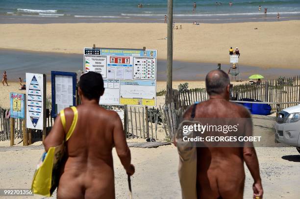 Graphic content / Naked people walk to the beach of the Arnaoutchot naturist camping on June 26, 2018 in Vielle-Saint-Girons, southwestern France. -...