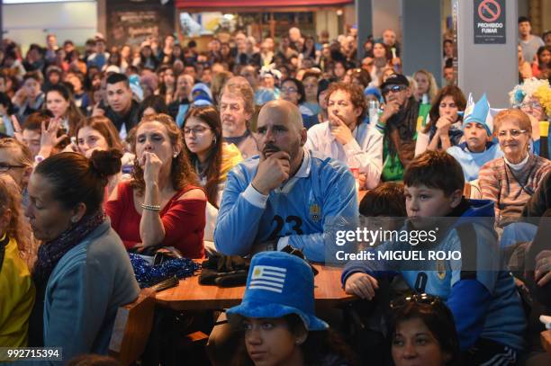 Fans of Uruguay attend the broadcasting of the Russia 2018 FIFA World Cup football match Uruguay against France on a big screen at the Mercado...