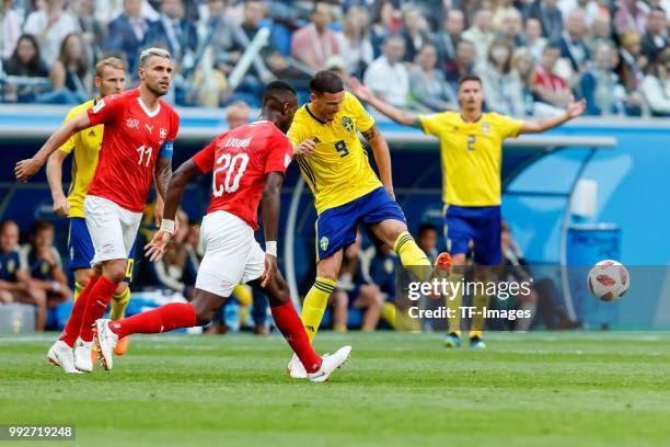 Johan Djourou of Switzerland and Marcus Berg of Sweden battle for the ball during the 2018 FIFA World Cup Russia Round of 16 match between Sweden and...