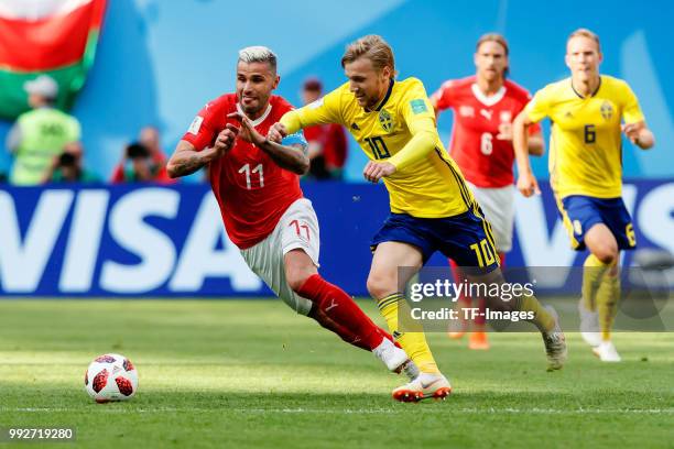 Valon Behrami of Switzerland and Emil Forsberg of Sweden battle for the ball during the 2018 FIFA World Cup Russia Round of 16 match between Sweden...