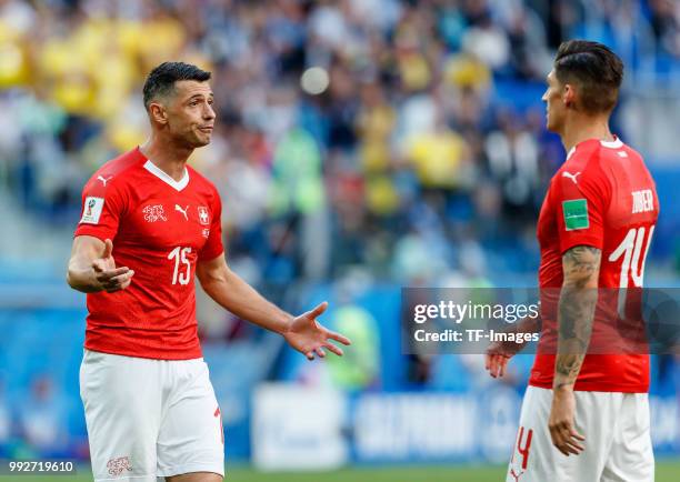 Blerim Dzemaili of Switzerland speaks with Steven Zuber of Switzerland during the 2018 FIFA World Cup Russia Round of 16 match between Sweden and...