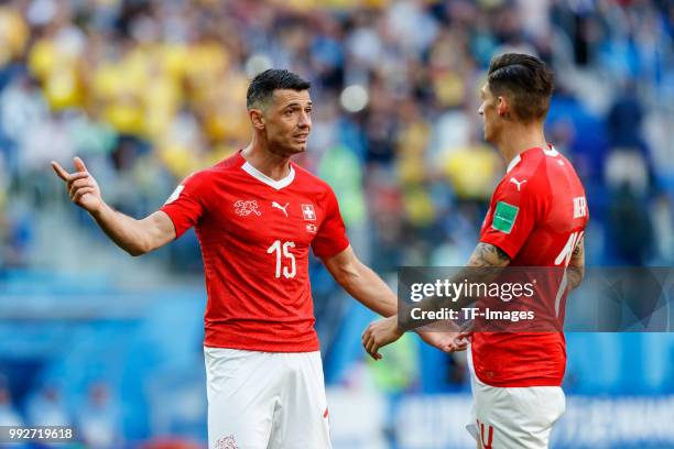 Blerim Dzemaili of Switzerland speaks with Steven Zuber of Switzerland during the 2018 FIFA World Cup Russia Round of 16 match between Sweden and...