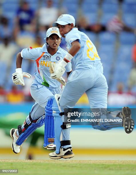 Indian cricketers Harmanpreet Kaur and Poonam Raul take a run during the ICC Women�s World Cup Twenty20 semi final match between Australia and India...