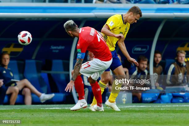 Valon Behrami of Switzerland and Viktor Claesson of Sweden battle for the ball during the 2018 FIFA World Cup Russia Round of 16 match between Sweden...