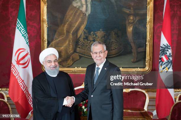 Austrian President Alexander van der Bellen and Iranian President Hassan Rouhani shake hands prior their meeting at Hofburg Palace on July 4, 2018 in...