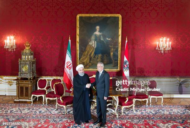 Austrian President Alexander van der Bellen and Iranian President Hassan Rouhani shake hands prior their meeting at Hofburg Palace on July 4, 2018 in...